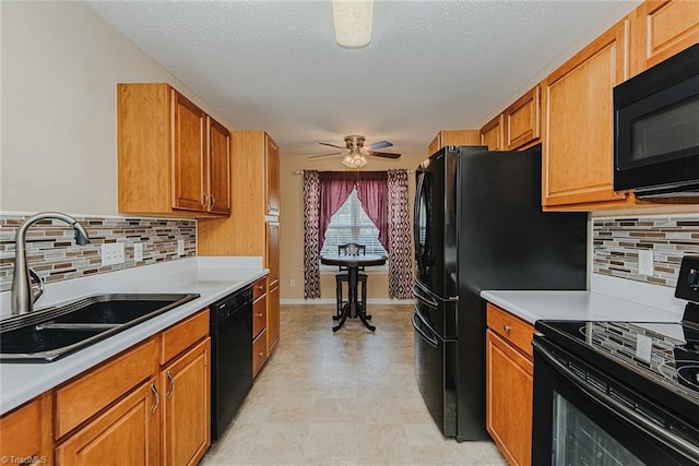 101 Kingston Ln, Graham, NC 27253 - kitchen featuring black appliances, light countertops, brown cabinets, and a textured ceiling