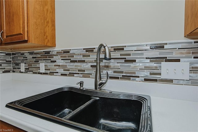 101 Kingston Ln, Graham, NC 27253 - kitchen view of decorative backsplash, brown cabinets, and light countertops