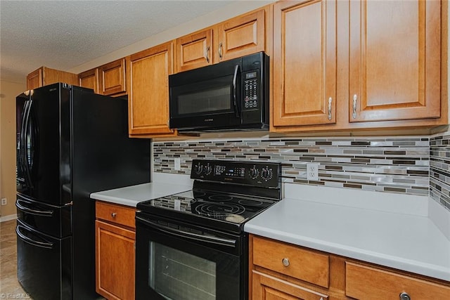 101 Kingston Ln, Graham, NC 27253 - kitchen featuring black appliances, light countertops, decorative backsplash, brown cabinets, and a textured ceiling