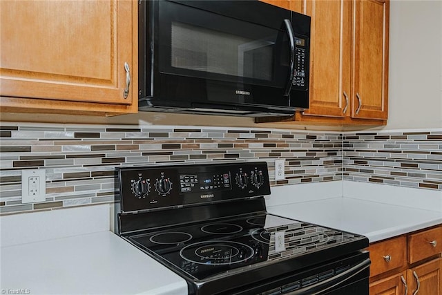 101 Kingston Ln, Graham, NC 27253 - kitchen view of black appliances, brown cabinets, and tasteful backsplash