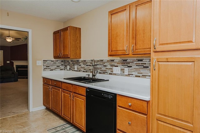 101 Kingston Ln, Graham, NC 27253 - kitchen featuring black dishwasher, a ceiling fan, light countertops, a fireplace, and tasteful backsplash