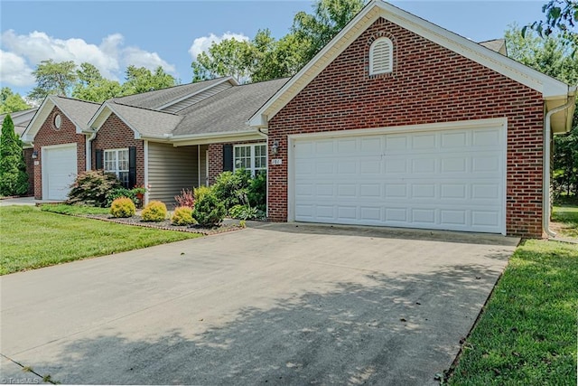 101 Kingston Ln, Graham, NC 27253 - ranch-style house with brick siding, an attached garage, driveway, and a front yard