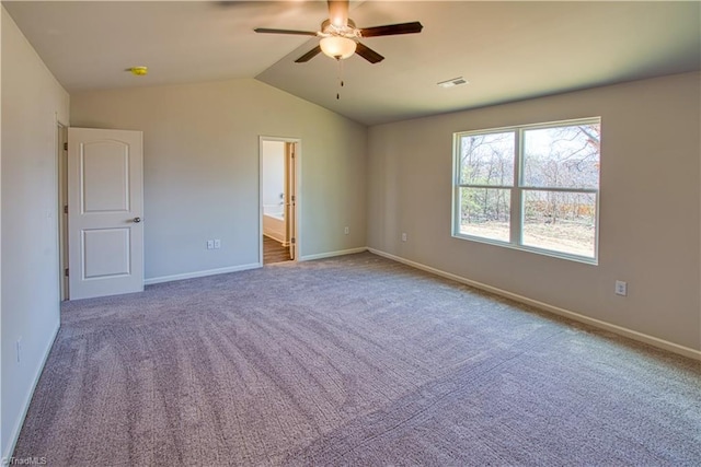 unfurnished bedroom featuring ensuite bathroom, carpet flooring, visible vents, baseboards, and vaulted ceiling