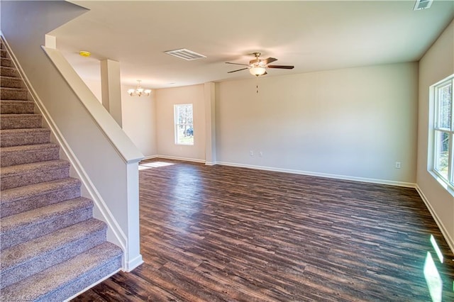 interior space featuring baseboards, stairs, visible vents, and dark wood finished floors