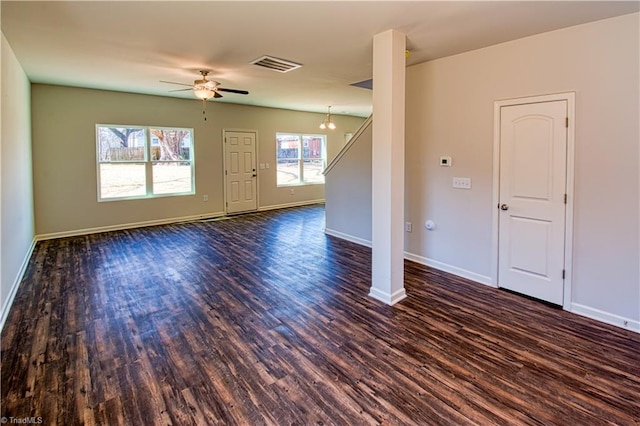 unfurnished living room featuring dark wood-style floors, baseboards, and visible vents