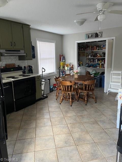 dining area with light tile patterned floors, a textured ceiling, and a ceiling fan