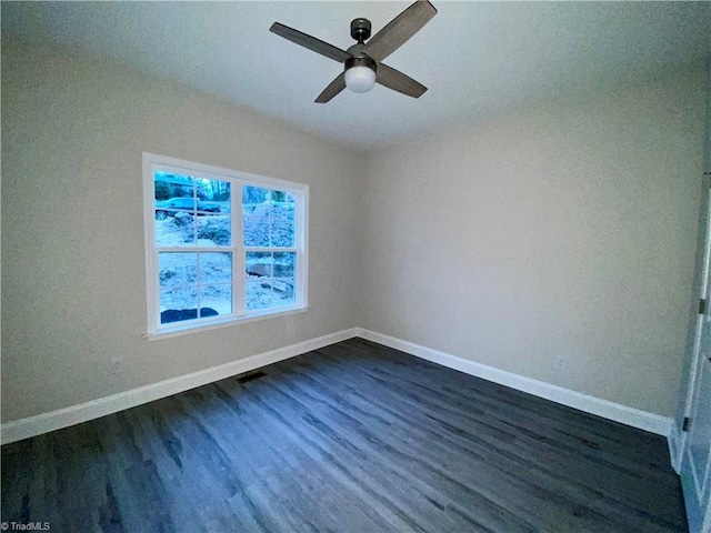 spare room with dark hardwood / wood-style floors and ceiling fan