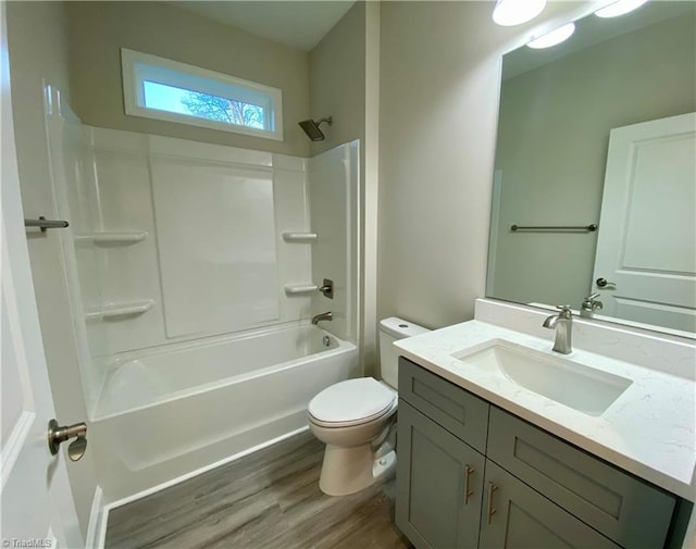 full bathroom featuring shower / washtub combination, hardwood / wood-style floors, vanity, and toilet