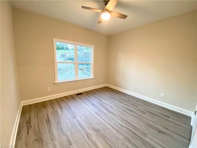 spare room featuring ceiling fan and wood-type flooring