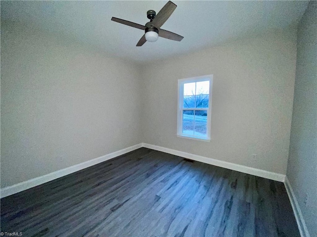 empty room featuring ceiling fan and dark hardwood / wood-style flooring