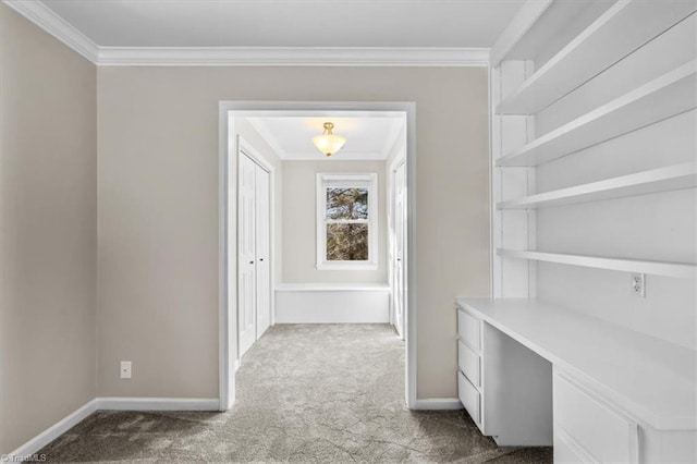 interior space featuring carpet, baseboards, and crown molding