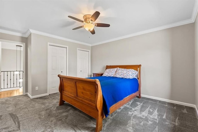 bedroom featuring two closets, ornamental molding, a ceiling fan, carpet flooring, and baseboards