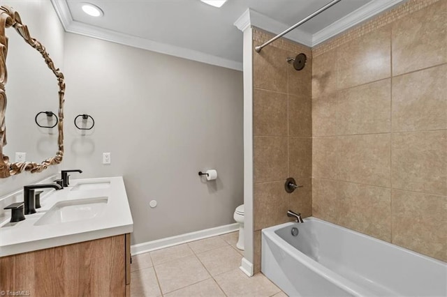 bathroom featuring toilet, a sink, crown molding, and tile patterned floors