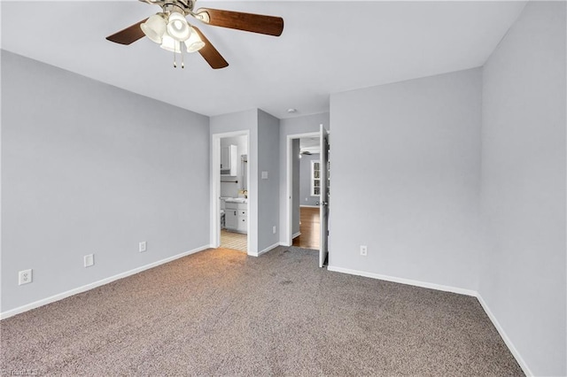 unfurnished bedroom featuring ceiling fan, ensuite bathroom, baseboards, and carpet floors