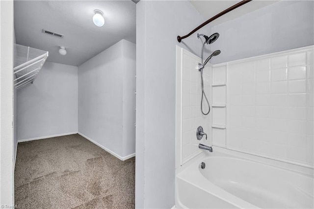 bathroom with visible vents, washtub / shower combination, and baseboards