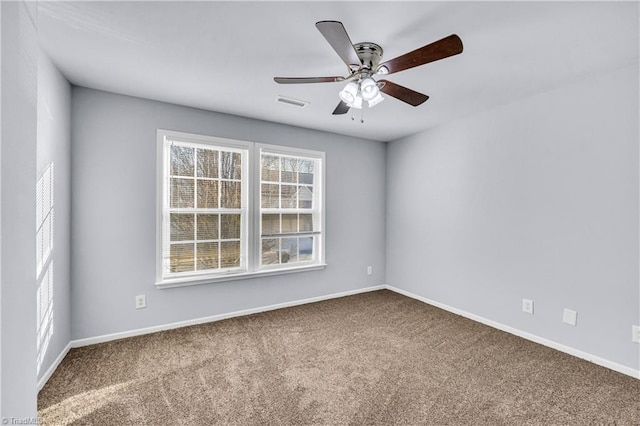 carpeted empty room featuring a ceiling fan, baseboards, and visible vents