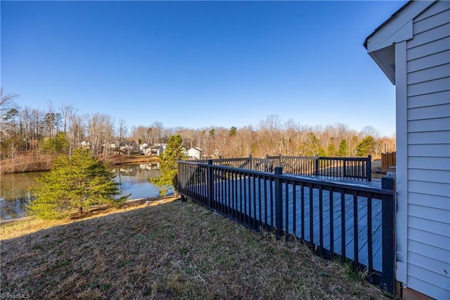 view of yard with a deck with water view