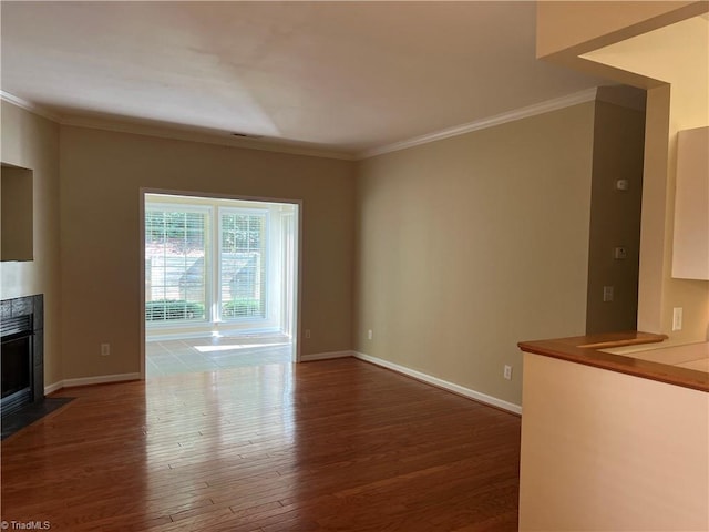 unfurnished living room with dark hardwood / wood-style flooring and crown molding