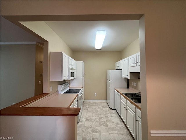 kitchen with kitchen peninsula, sink, white appliances, white cabinetry, and ornamental molding