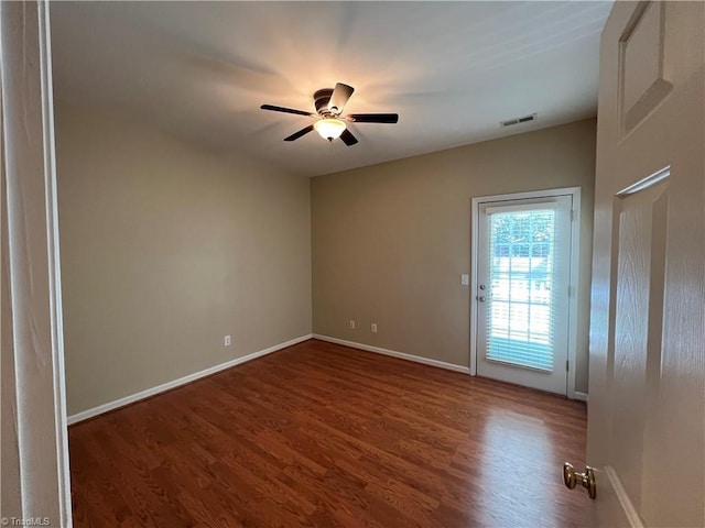 spare room with ceiling fan and dark hardwood / wood-style flooring