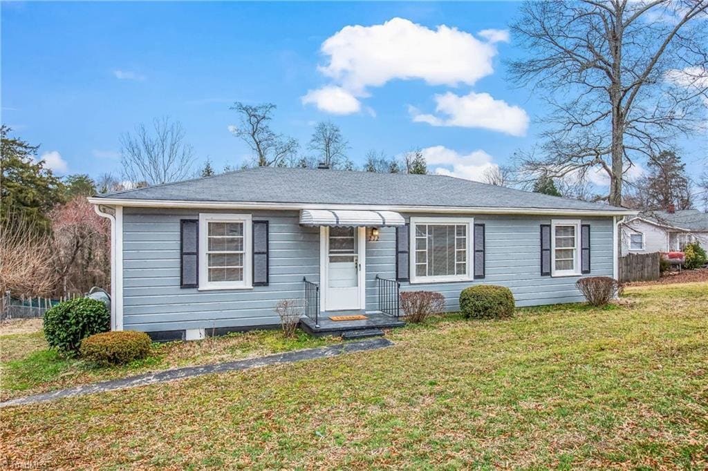 view of front of property with a front yard and fence