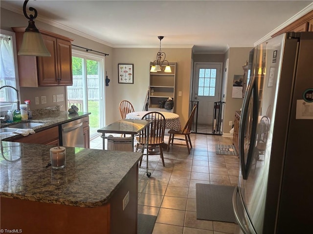 113 Spencer St, Randleman, NC 27317 - kitchen with stainless steel appliances, a sink, light tile patterned floors, hanging light fixtures, and dark stone counters