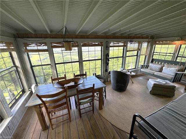 sunroom / solarium featuring beam ceiling and hardwood / wood-style floors