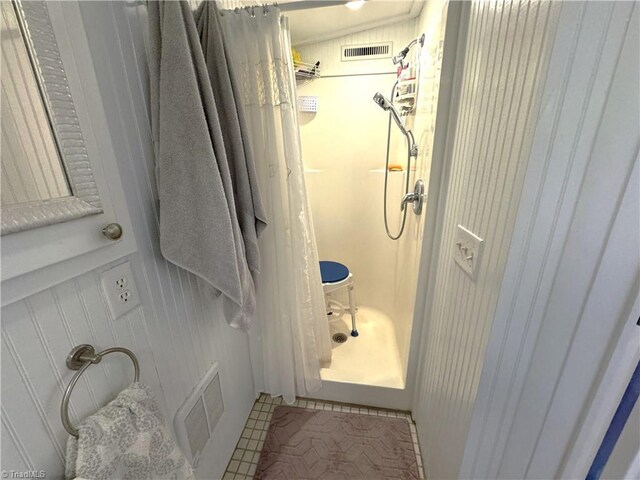 full bathroom featuring a shower and visible vents