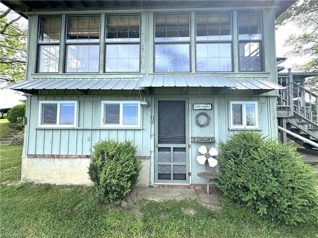 view of front of property featuring stairway and board and batten siding