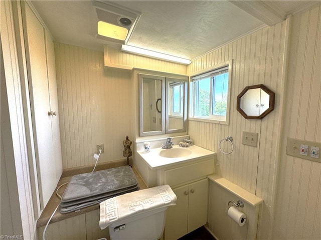 half bathroom featuring toilet and vanity