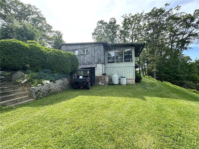 rear view of property with a lawn