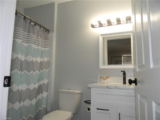 bathroom featuring vanity, toilet, and a shower with shower curtain