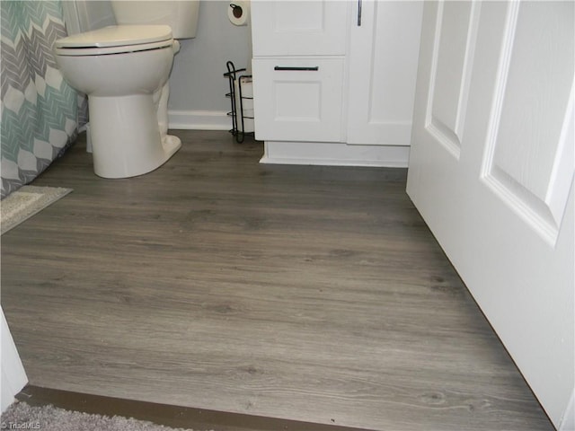 bathroom featuring hardwood / wood-style floors and toilet