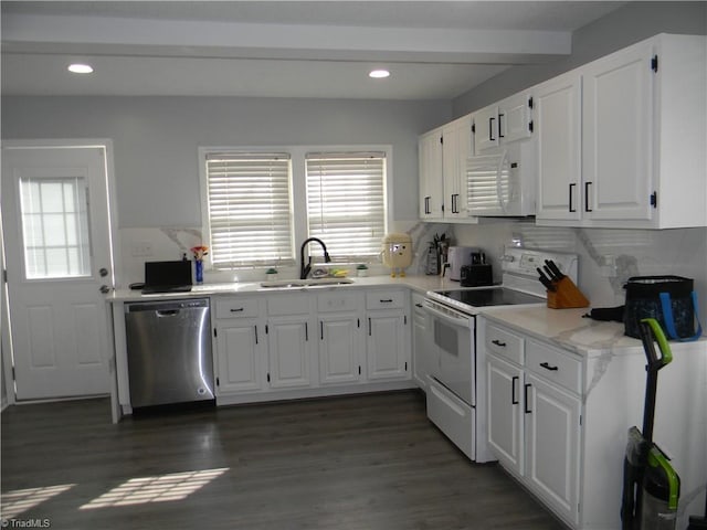 kitchen with dark hardwood / wood-style floors, white cabinetry, sink, and white appliances