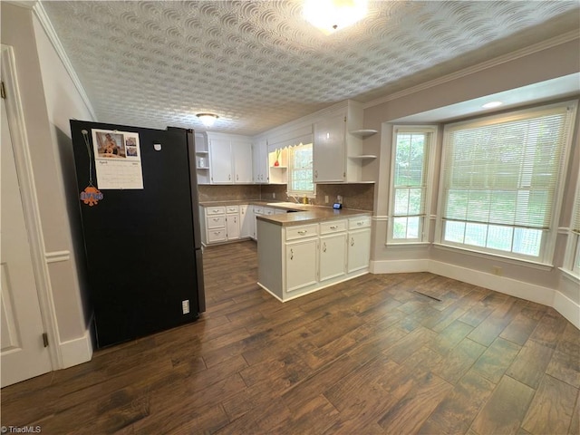 kitchen featuring freestanding refrigerator, open shelves, ornamental molding, and white cabinets