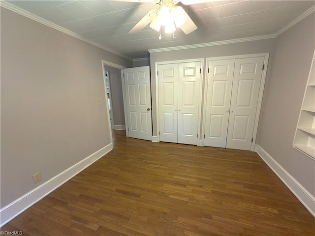 unfurnished bedroom featuring crown molding, baseboards, and wood finished floors