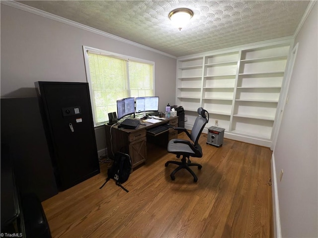home office with crown molding, built in features, baseboards, and wood finished floors