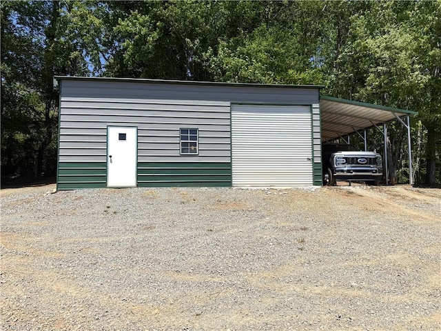 garage featuring driveway and a carport