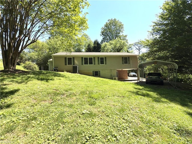 rear view of house featuring a lawn, central air condition unit, and a carport