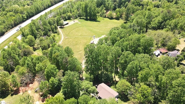 drone / aerial view featuring a wooded view