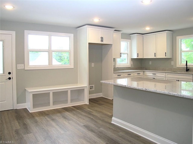 812 Midway School Rd, Winston-Salem, NC 27107 - kitchen featuring a sink, light stone counters, white cabinets, dark wood-style floors, and baseboards