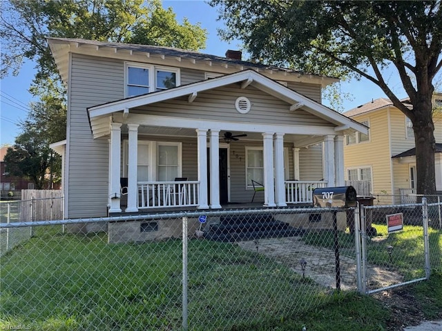 view of front of house with a porch, a front lawn, and ceiling fan