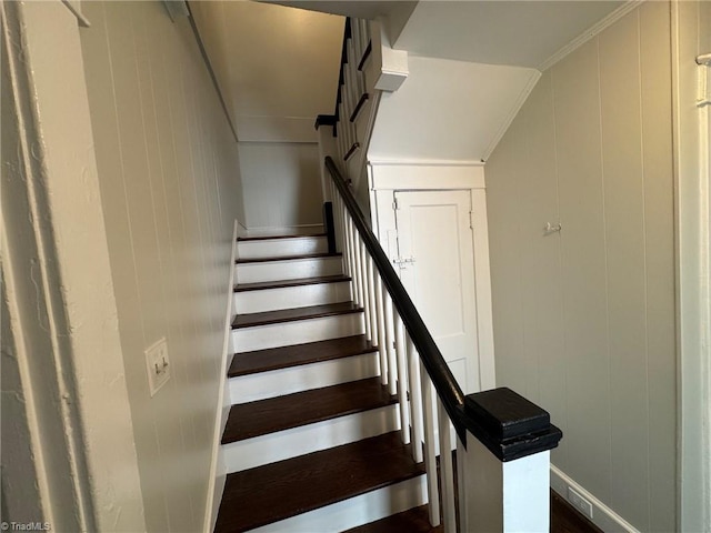 staircase featuring ornamental molding and hardwood / wood-style flooring