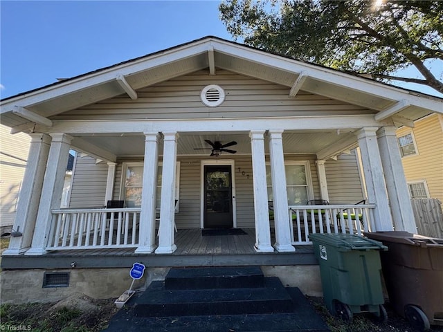 view of exterior entry featuring ceiling fan and a porch