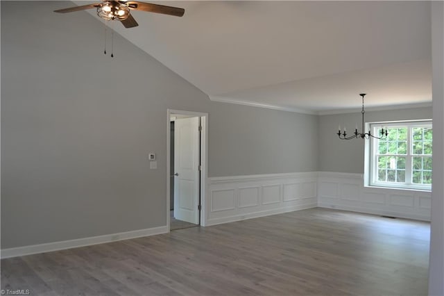 spare room with crown molding, high vaulted ceiling, ceiling fan with notable chandelier, and hardwood / wood-style flooring