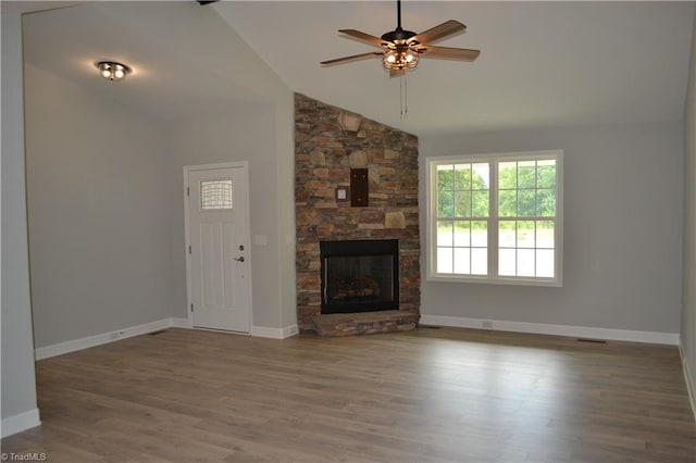 unfurnished living room featuring a fireplace, ceiling fan, hardwood / wood-style floors, and high vaulted ceiling