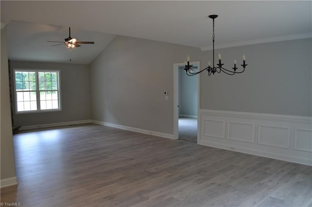 unfurnished room featuring wood-type flooring, ceiling fan with notable chandelier, crown molding, and lofted ceiling