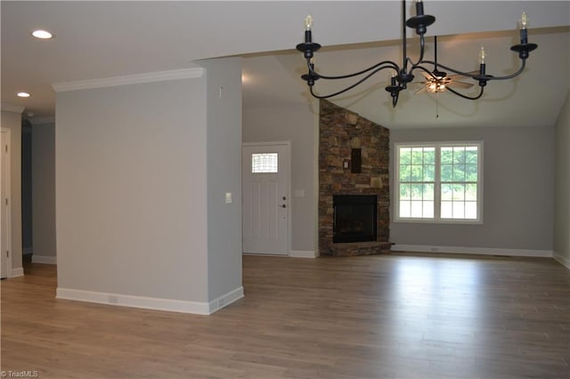 unfurnished living room with a stone fireplace, crown molding, wood-type flooring, and lofted ceiling