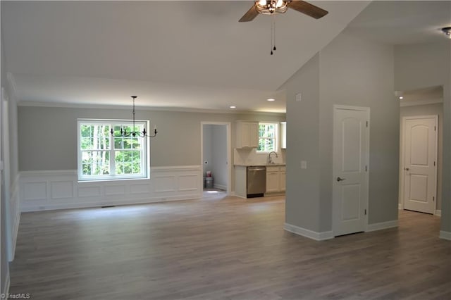 spare room featuring plenty of natural light, light wood-type flooring, and high vaulted ceiling