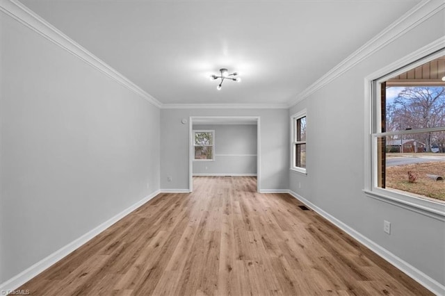 unfurnished room with ornamental molding, baseboards, and wood finished floors